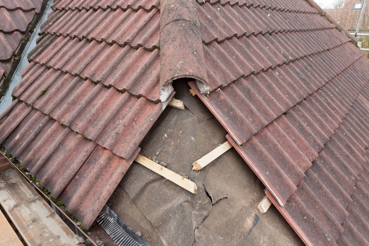 A Smart Call Contractors roofer working on a pitched roof